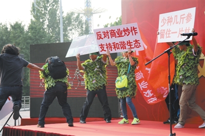 前日，朝阳公园举行“重走人参路”推广活动，几位环保人士举牌抗议毁林种参，后被公园保安制止、带离